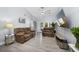 Bright living room with hardwood floors, ceiling fan, and a comfortable seating area at 12133 Augusta Woods Cir, Orlando, FL 32824