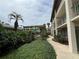 Condo complex with lush tropical landscaping and sidewalks between the building and pool area at 122 Water Front Way # 360, Altamonte Springs, FL 32701