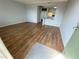 Open-concept living room with wood-look floors and pass-through to the kitchen at 122 Water Front Way # 360, Altamonte Springs, FL 32701