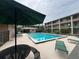 Community pool with multiple lounge chairs and tables at condo complex at 122 Water Front Way # 360, Altamonte Springs, FL 32701