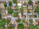 Overhead shot showing houses nestled amongst the trees, and some with personal pools at 130 Aragon Ave, Umatilla, FL 32784