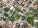 Bird's-eye perspective of homes, showcasing yards, driveways, and street layouts at 130 Aragon Ave, Umatilla, FL 32784