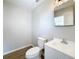 A half bathroom features modern fixtures, including a new toilet and a pedestal sink at 130 Aragon Ave, Umatilla, FL 32784