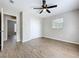 The bedroom has a ceiling fan, wood-look floors, closet, and neutral paint at 130 Aragon Ave, Umatilla, FL 32784