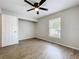 Bedroom features modern ceiling fan, window bringing in natural light and wood-look flooring at 130 Aragon Ave, Umatilla, FL 32784