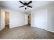 The bedroom has a ceiling fan, wood-look floors, closet, and neutral paint at 130 Aragon Ave, Umatilla, FL 32784
