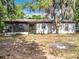 Charming single-story home with a screened lanai and mature trees at 130 Aragon Ave, Umatilla, FL 32784