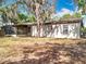 Charming single-story home with a screened lanai and mature trees at 130 Aragon Ave, Umatilla, FL 32784
