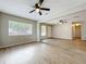 Bright and open living area featuring sleek flooring, fresh paint, and abundant light at 130 Aragon Ave, Umatilla, FL 32784
