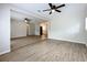 Spacious living area featuring modern flooring and seamless flow into the kitchen at 130 Aragon Ave, Umatilla, FL 32784