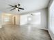 Spacious living room with modern flooring, neutral paint, and abundant natural light at 130 Aragon Ave, Umatilla, FL 32784