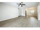 Bright and airy living room featuring modern floors and a ceiling fan at 130 Aragon Ave, Umatilla, FL 32784