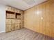 A secondary room featuring custom wood paneling and built-in storage at 130 Aragon Ave, Umatilla, FL 32784