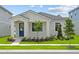 Charming single-story home with a well-maintained lawn and inviting blue front door at 13046 Pergola Ave, Orlando, FL 32832