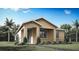 Charming single-story home featuring a neutral color palette, well-manicured lawn, and inviting entrance at 13046 Pergola Ave, Orlando, FL 32832