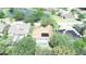 Aerial view of a home with a screened in pool and solar panels near a scenic pond at 13250 Meergate Cir, Orlando, FL 32837