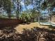 Spacious backyard with screened pool area and mature trees at 13250 Meergate Cir, Orlando, FL 32837