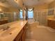 Bathroom with double vanity, walk-in shower, and soaking tub perfect for relaxing at 13250 Meergate Cir, Orlando, FL 32837