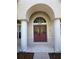 Inviting front entrance featuring double doors and elegant architectural details at 13250 Meergate Cir, Orlando, FL 32837