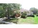 Well-manicured lawn and mature landscaping enhance this charming single-story home at 13250 Meergate Cir, Orlando, FL 32837