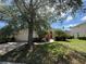 This home boasts a large tree and a beautifully landscaped front yard at 13250 Meergate Cir, Orlando, FL 32837