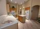 Open kitchen featuring an island, stainless appliances, light countertops, and tile flooring at 13250 Meergate Cir, Orlando, FL 32837