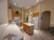 Bright kitchen with island, white appliances, and maple-colored cabinetry at 13250 Meergate Cir, Orlando, FL 32837