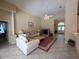 Spacious living room featuring neutral decor, high ceilings, and a view towards the front entrance at 13250 Meergate Cir, Orlando, FL 32837