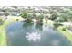 Scenic aerial view of a pond with a fountain in a residential community at 13250 Meergate Cir, Orlando, FL 32837