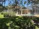 Landscaped backyard with screened-in pool at 13250 Meergate Cir, Orlando, FL 32837
