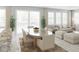 Elegant dining room featuring a table with seating, and an adjacent open living space at 13271 Pergola Ave, Orlando, FL 32832