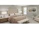 Serene main bedroom with tufted headboard, soft neutral tones, and ample natural light at 13271 Pergola Ave, Orlando, FL 32832