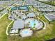 An aerial view of community amenities featuring a pool, splashpad, seating, and palm trees at 13807 Tybee Beach Ln, Orlando, FL 32827