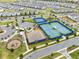 An aerial view shows a community park and tennis courts near single-Gathering homes at 13807 Tybee Beach Ln, Orlando, FL 32827