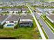 An aerial view of single-Gathering homes with pools and screened-in lanais, nestled in a vibrant community near a waterway at 13807 Tybee Beach Ln, Orlando, FL 32827