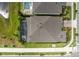 An aerial view shows a home with a screened in pool area and well maintained landscaping and adjacent sidewalk at 13807 Tybee Beach Ln, Orlando, FL 32827