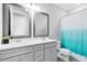 Bathroom with double sink vanity, quartz countertops, and grey cabinets at 13807 Tybee Beach Ln, Orlando, FL 32827