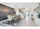 Elegant dining room featuring a stylish chandelier, wood accent wall, staircase and an open view to the entryway at 13807 Tybee Beach Ln, Orlando, FL 32827