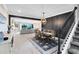 Elegant dining room with a stylish chandelier, wood accent wall, staircase and an open view to the living area at 13807 Tybee Beach Ln, Orlando, FL 32827