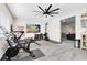 Bright home gym featuring various exercise equipment and a ceiling fan at 13807 Tybee Beach Ln, Orlando, FL 32827