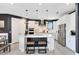 Bright kitchen with white cabinets, stainless steel appliances, a large island with seating, and modern pendant lighting at 13807 Tybee Beach Ln, Orlando, FL 32827