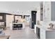 Bright, open kitchen with white cabinets, large island, bar with wine cooler, and modern finishes at 13807 Tybee Beach Ln, Orlando, FL 32827