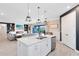 Open-concept kitchen island leading to a living area with a fireplace and backyard view at 13807 Tybee Beach Ln, Orlando, FL 32827