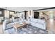Spacious living room featuring modern decor, plush seating, and an open layout with seamless flow to the kitchen at 13807 Tybee Beach Ln, Orlando, FL 32827