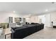Spacious living room with gray sectional, custom built-ins, and plenty of seating space at 13807 Tybee Beach Ln, Orlando, FL 32827