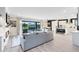 Bright, open concept living area showcasing seamless transition to the kitchen, dining, and outdoor spaces at 13807 Tybee Beach Ln, Orlando, FL 32827