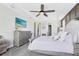Spacious main bedroom featuring a tray ceiling, ceiling fan, and elegant furnishings at 13807 Tybee Beach Ln, Orlando, FL 32827