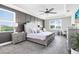Luxurious main bedroom with a panel accent wall, ceiling fan, and natural light at 13807 Tybee Beach Ln, Orlando, FL 32827
