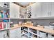 Well-organized pantry with custom shelves, cabinets, wine rack, and countertop space at 13807 Tybee Beach Ln, Orlando, FL 32827