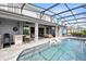 Swimming pool with outdoor living space and outdoor kitchen and bar at 13807 Tybee Beach Ln, Orlando, FL 32827